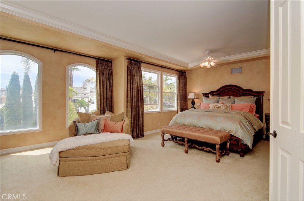 21 Asilomar Road Laguna Niguel, CA 92677 - Photo 9 of 35 a bedroom with a bed and large windows