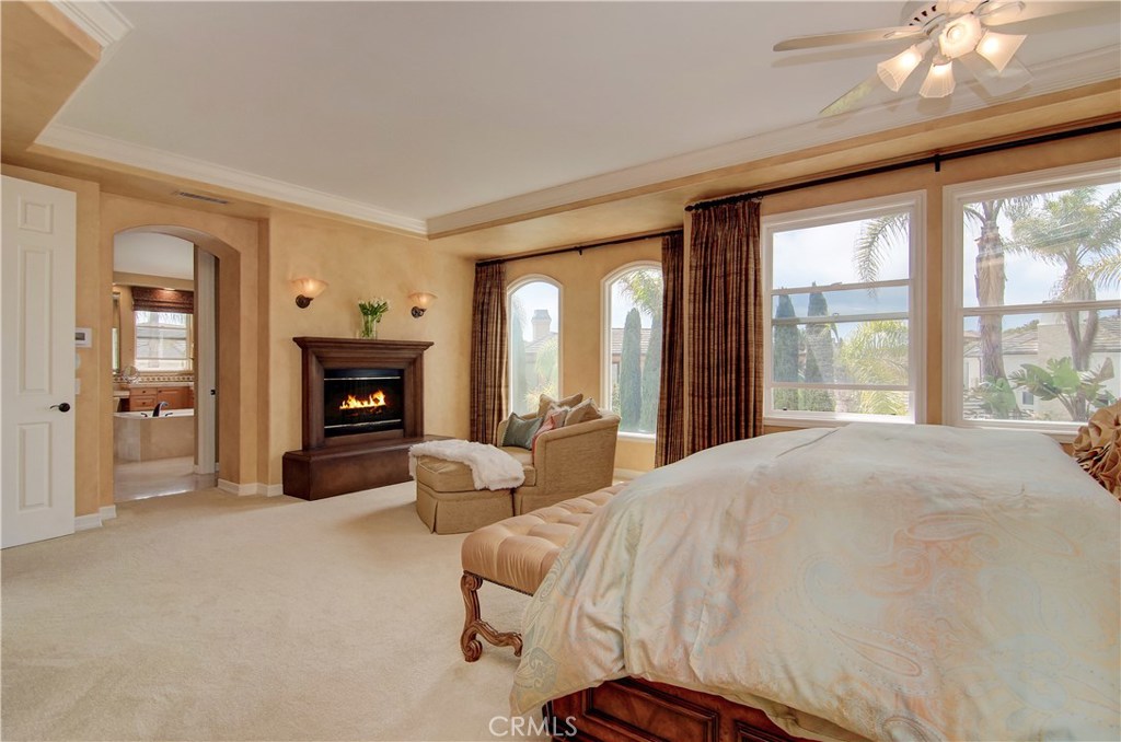 21 Asilomar Road Laguna Niguel, CA 92677 - Photo 10 of 35 a spacious bedroom with a balcony a bed and a fireplace