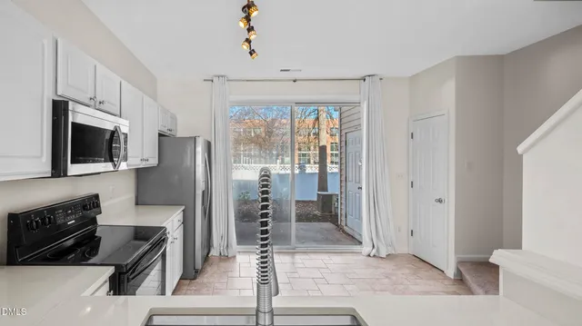 a kitchen with stainless steel appliances a stove microwave and a refrigerator