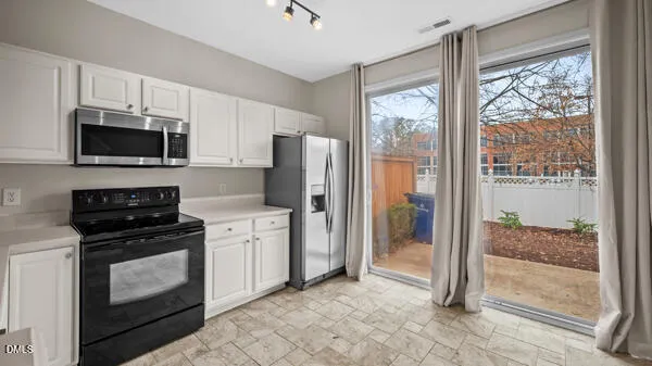 a kitchen with a refrigerator stove and microwave