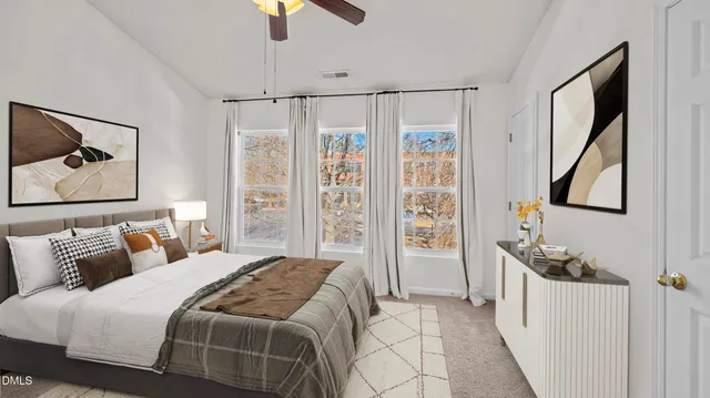 a bedroom with a bed and a painting on the wall