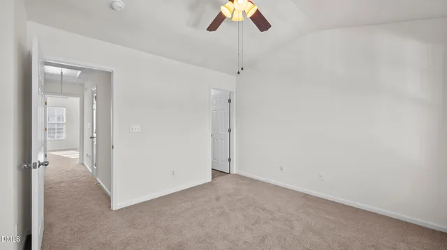 a view of a room with a ceiling fan and a shower