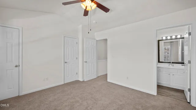 a view of a hallway with a chandelier fan