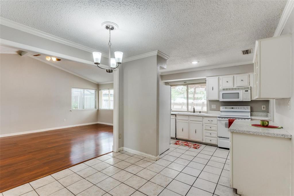 1708 Hendrick Drive Plano, TX 75074 - Photo 12 of 23 a kitchen with stainless steel appliances granite countertop a refrigerator and a stove top oven