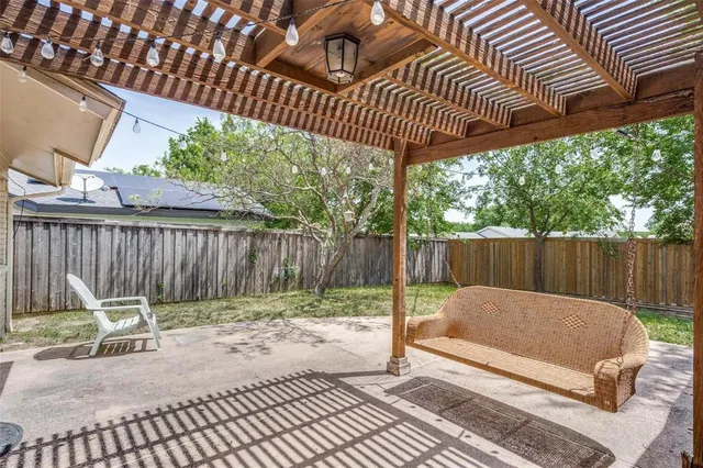 a view of a backyard with a slide tv and wooden fence