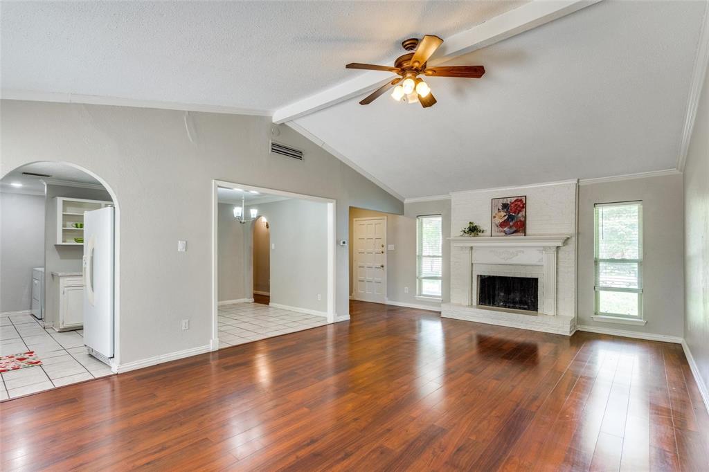 1708 Hendrick Drive Plano, TX 75074 - Photo 7 of 23 a view of a livingroom with wooden floor and a ceiling fan
