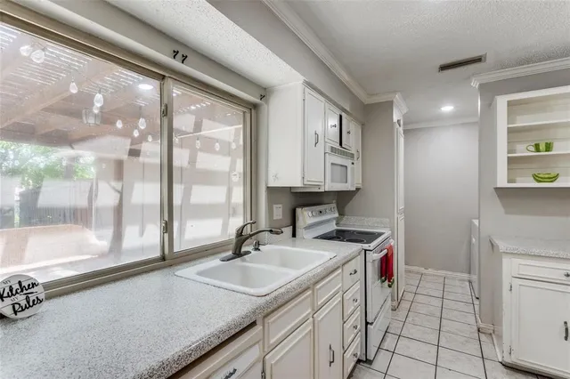 a kitchen with a sink a stove and a refrigerator