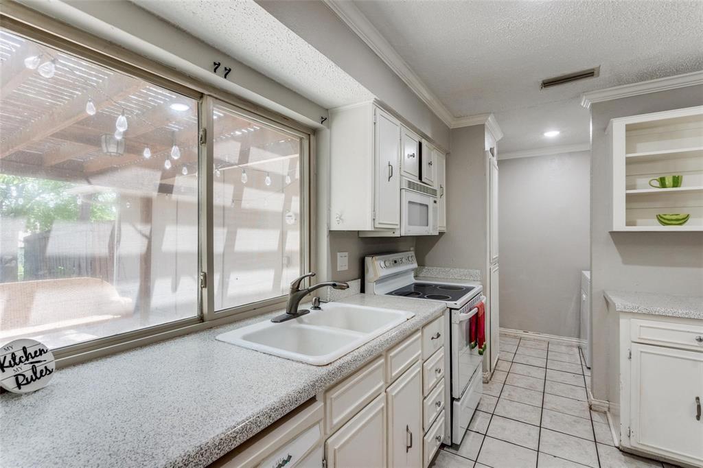 1708 Hendrick Drive Plano, TX 75074 - Photo 10 of 23 a kitchen with a sink a stove and a refrigerator
