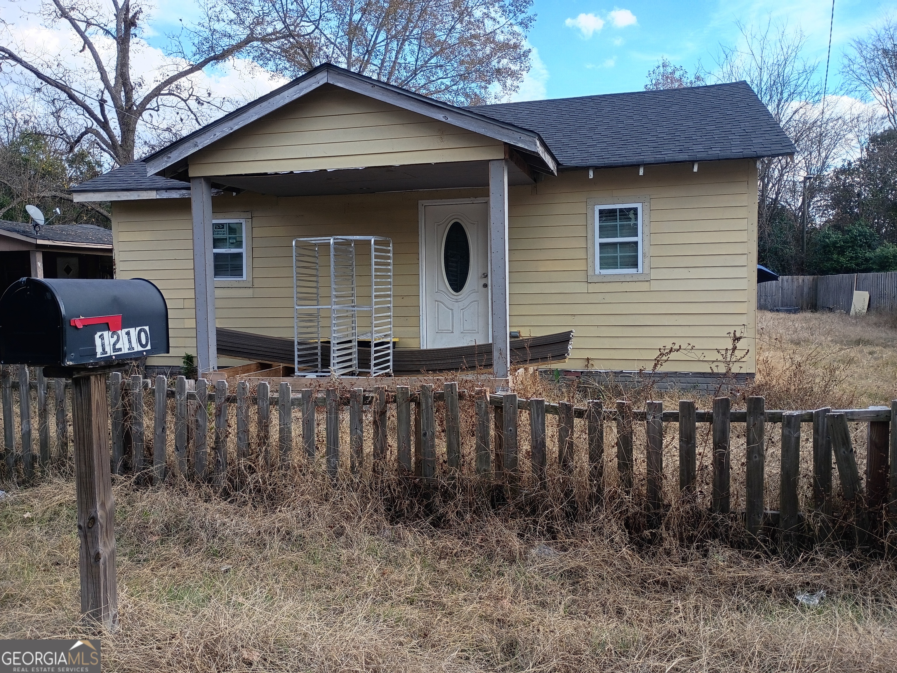 1210 Academy Avenue Dublin, GA 31021 - Photo 1 of 1 a view of house with wooden fence