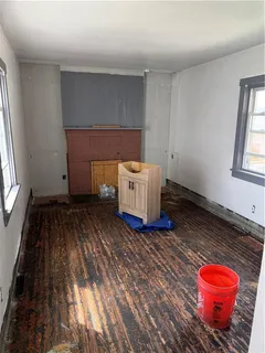a room with a wooden floor and window