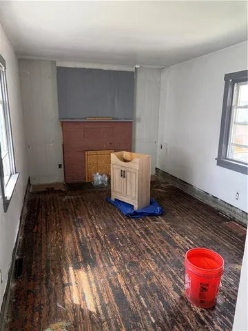 a room with a wooden floor and window