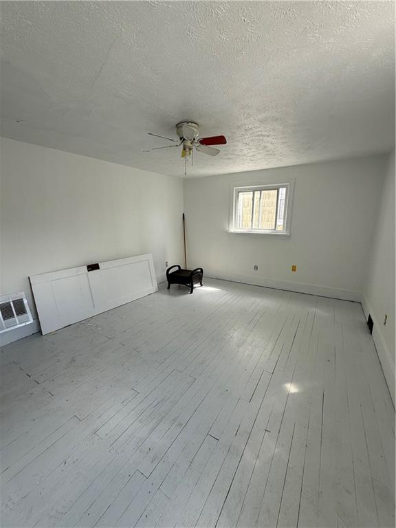 1717 Ridge Avenue New Kensington, PA 15068 - Photo 8 of 9 a view of an empty room with window and stairs