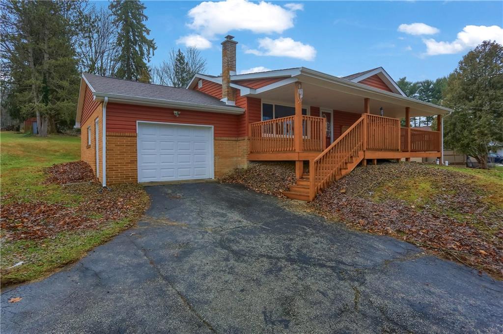138 Crissinger Road Greensburg, PA 15601 - Photo 2 of 28 a front view of a house with a yard and garage