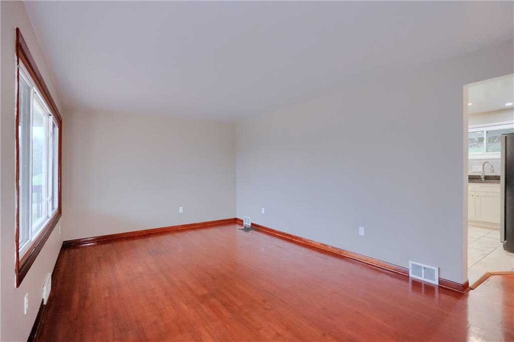 138 Crissinger Road Greensburg, PA 15601 - Photo 5 of 28 an empty room with wooden floor and windows