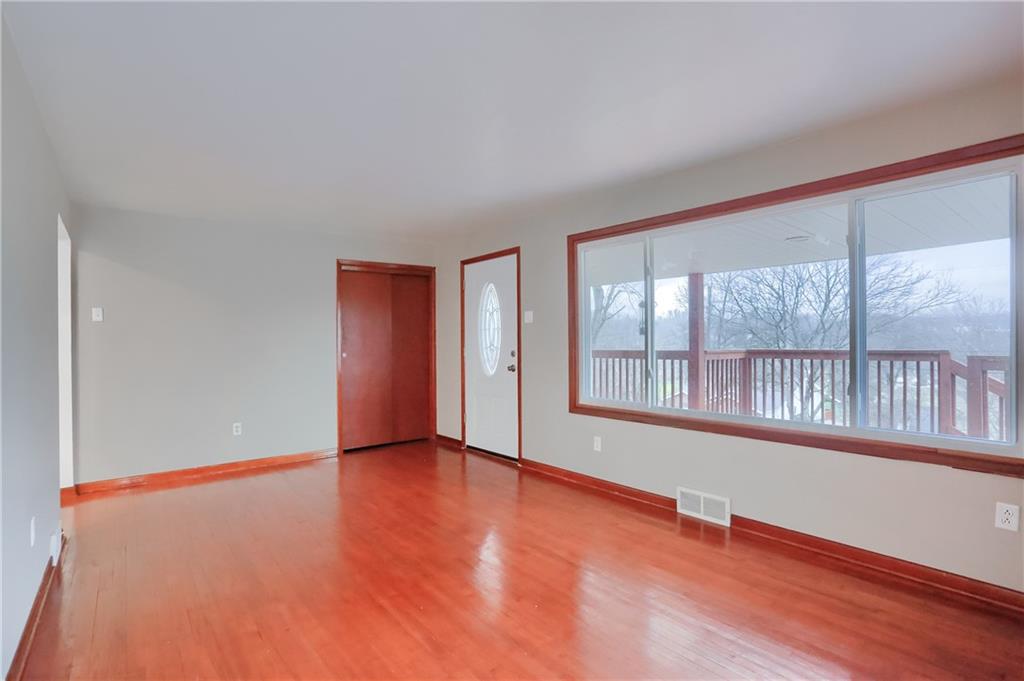 138 Crissinger Road Greensburg, PA 15601 - Photo 6 of 28 an empty room with wooden floor and windows