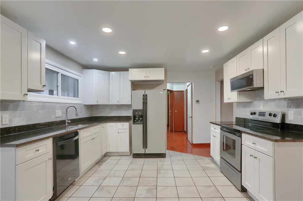 138 Crissinger Road Greensburg, PA 15601 - Photo 7 of 28 a kitchen with a sink a refrigerator and cabinets