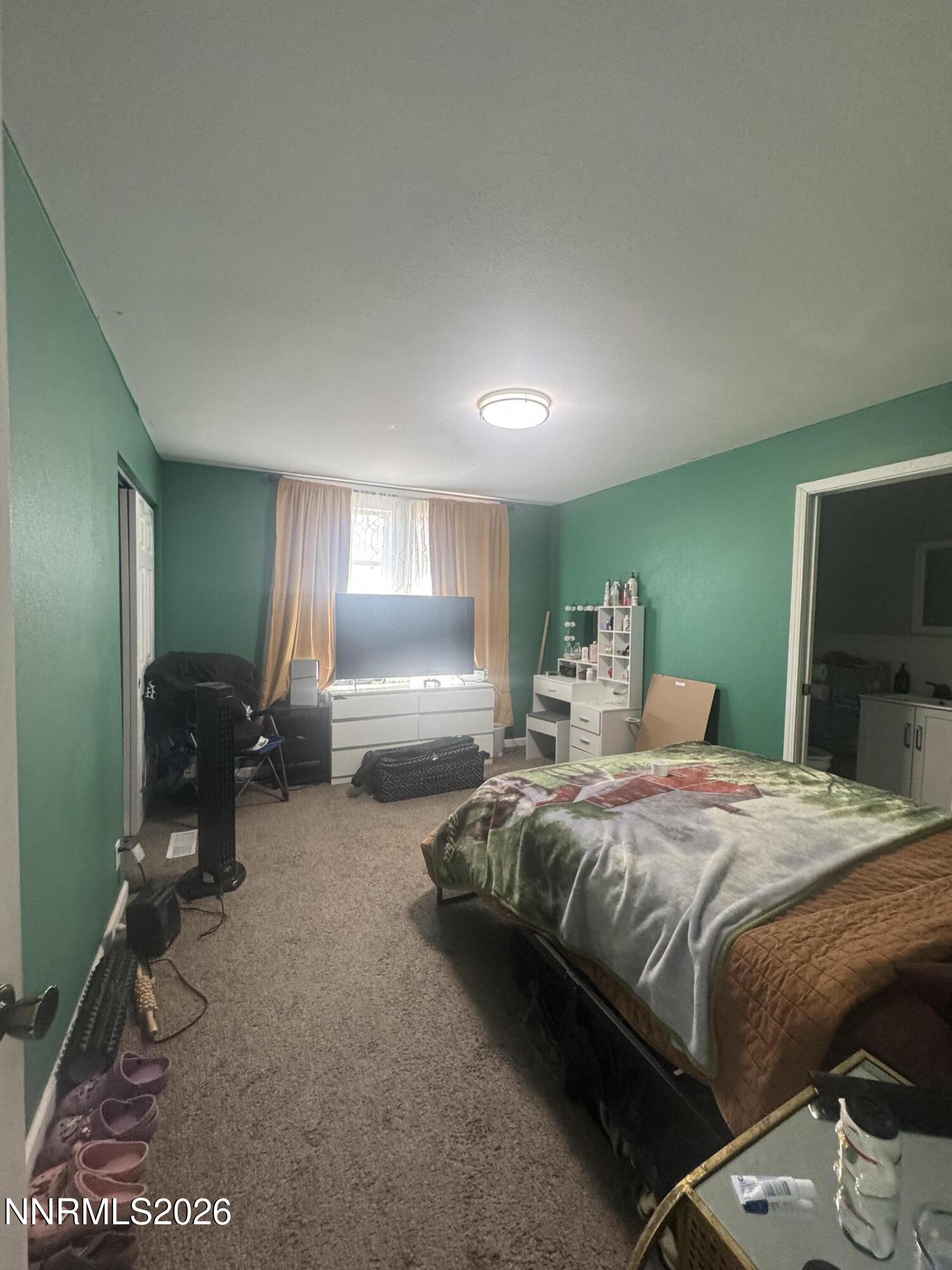 635 Churchill Street Fallon, NV 89406 - Photo 12 of 21 a bedroom with a bed and a tv