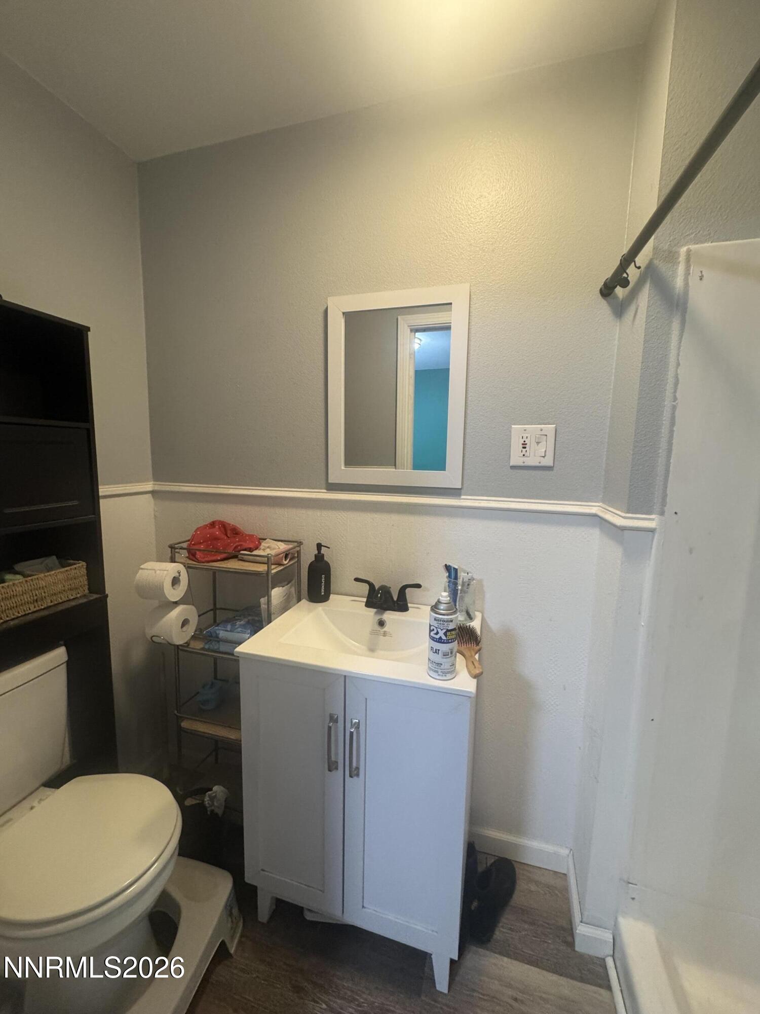 635 Churchill Street Fallon, NV 89406 - Photo 13 of 21 a bathroom with a toilet sink and mirror