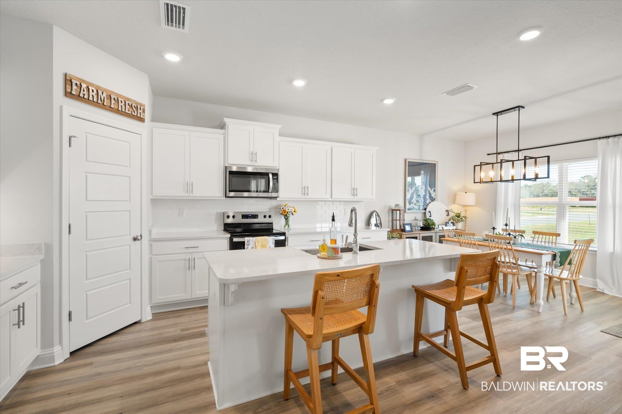 1167 Provision Road Mobile, AL 36608 - Photo 5 of 20 Kitchen with visible vents, an island with sink, a sink, stainless steel appliances, and light countertops