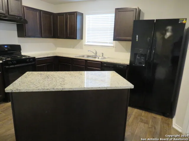 a kitchen with a sink and a refrigerator