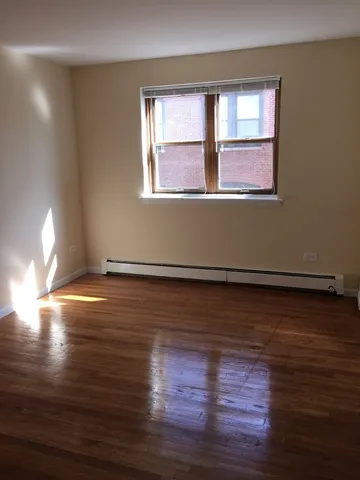 a room with wooden floor and windows
