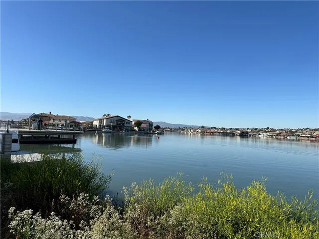 a view of a lake with boats and trees in the background