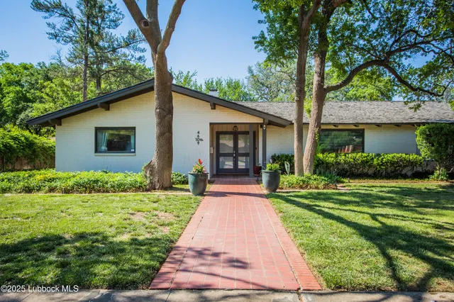 a view of a house with a small yard