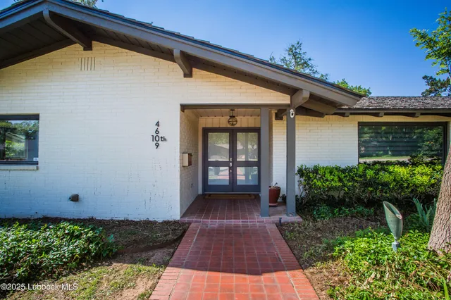 a kitchen with stainless steel appliances granite countertop a refrigerator sink and white cabinets