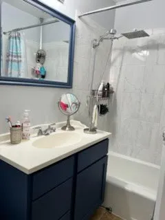 a bathroom with a sink vanity granite and a mirror