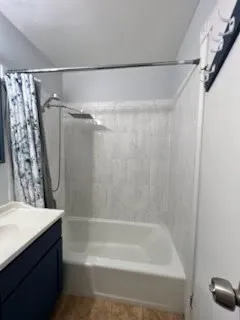 a bathroom with a shower curtain and a sink