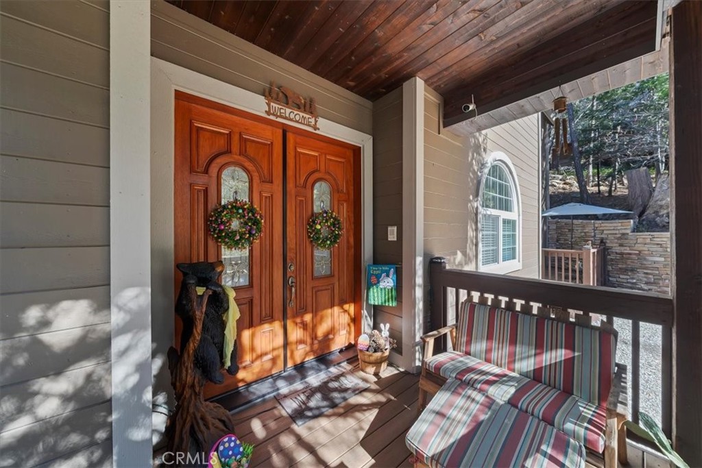 27312 Little Bear Road Lake Arrowhead, CA 92352 - Photo 11 of 47 a view of a porch with wooden floor
