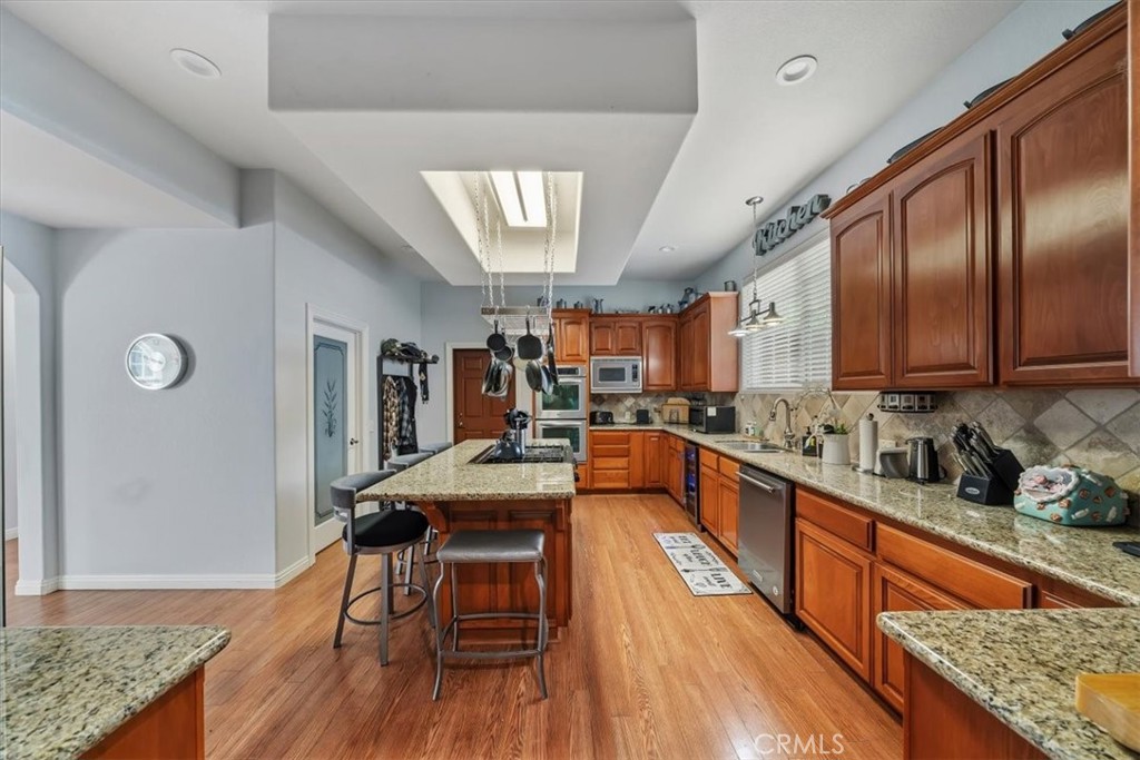 27312 Little Bear Road Lake Arrowhead, CA 92352 - Photo 15 of 47 a kitchen with stainless steel appliances granite countertop lots of counter top space and wooden floor
