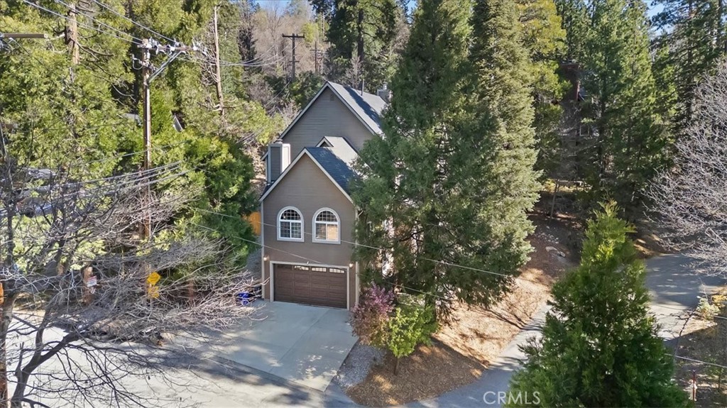 27312 Little Bear Road Lake Arrowhead, CA 92352 - Photo 2 of 47 a front view of a house with a yard and large trees