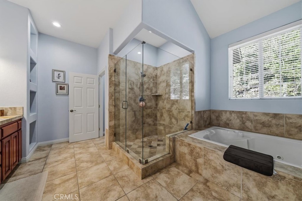 27312 Little Bear Road Lake Arrowhead, CA 92352 - Photo 27 of 47 a spacious bathroom with a tub shower and checkered floor