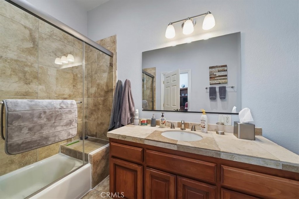 27312 Little Bear Road Lake Arrowhead, CA 92352 - Photo 29 of 47 a bathroom with a granite countertop sink mirror and a bath tub