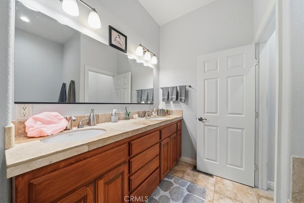 27312 Little Bear Road Lake Arrowhead, CA 92352 - Photo 35 of 47 a spacious bathroom with a double vanity sink and a mirror