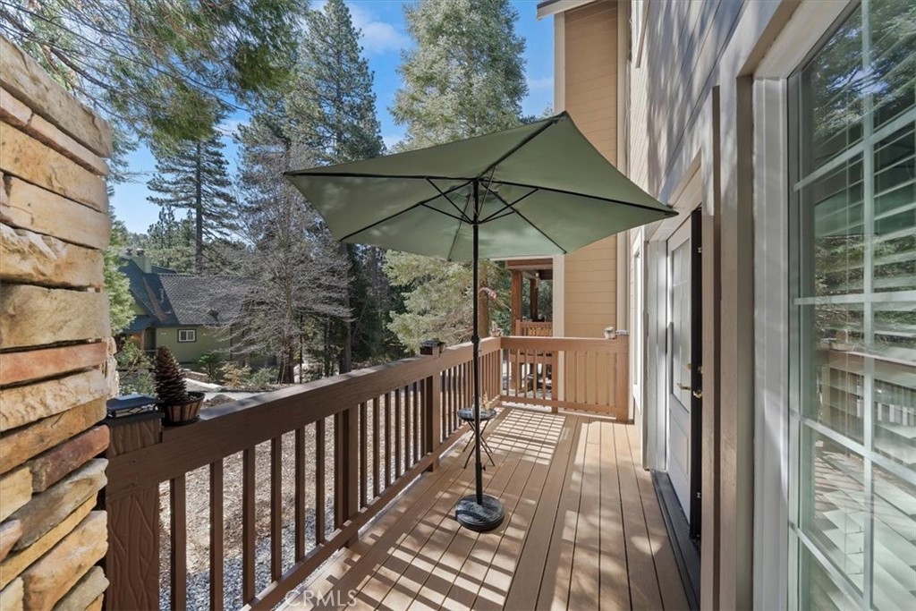 27312 Little Bear Road Lake Arrowhead, CA 92352 - Photo 39 of 47 a view of a balcony with wooden floor and outdoor seating