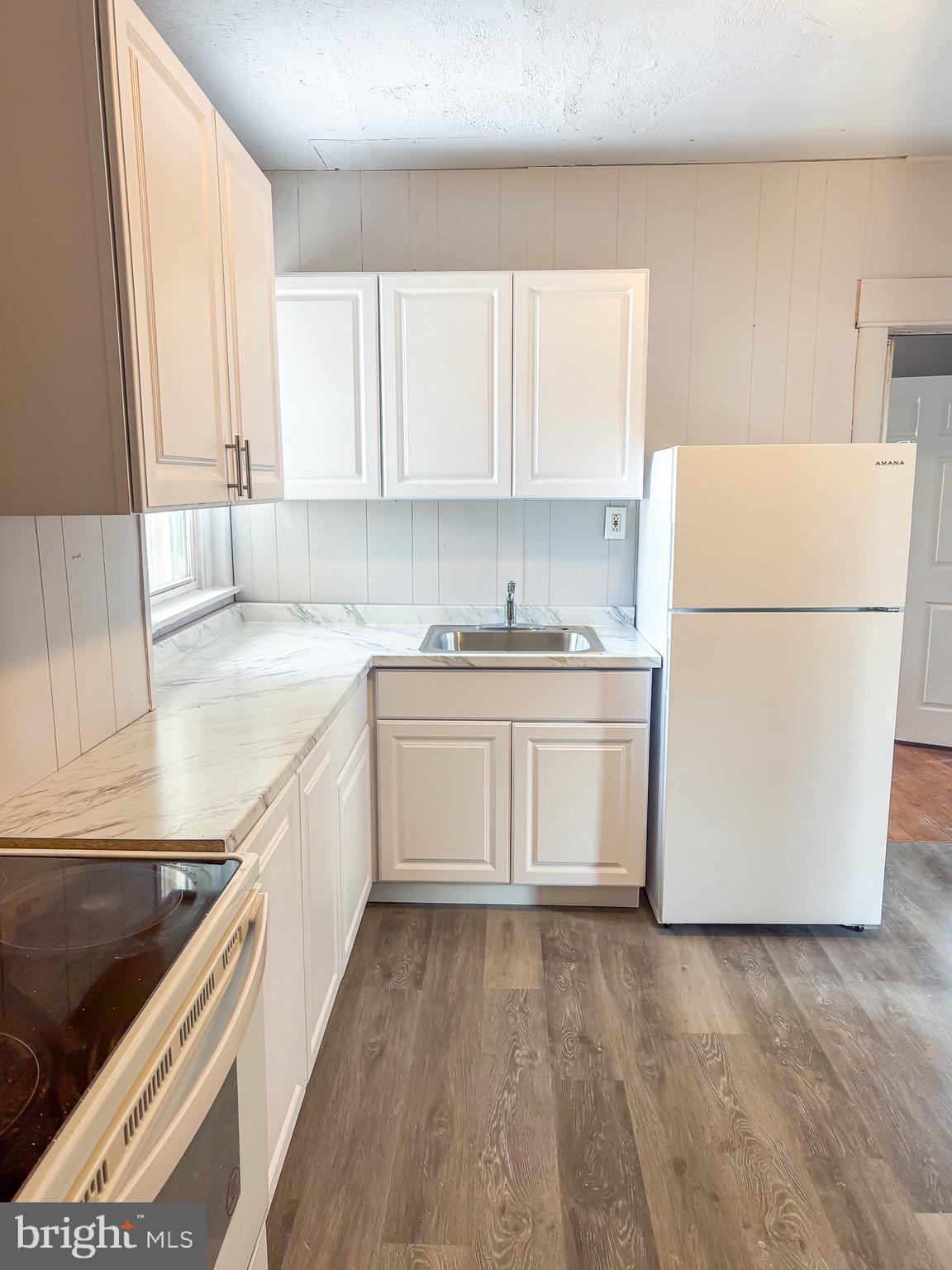 355 Nutt Road, Unit 1 Phoenixville, PA 19460 - Photo 3 of 3 a kitchen with a white cabinets and white appliances