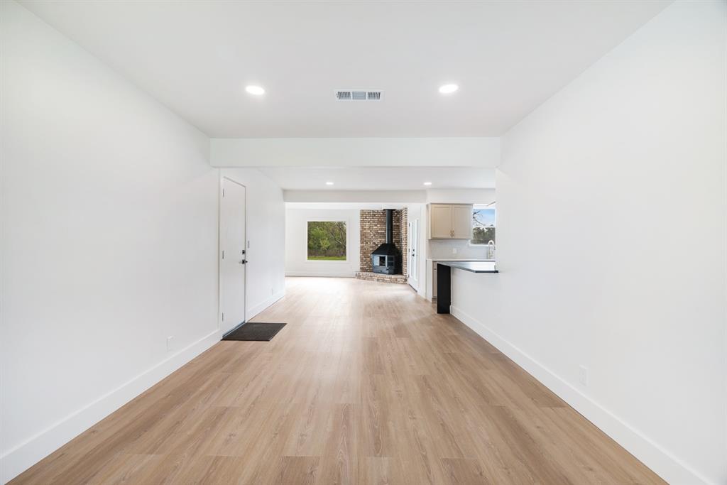 175 Cozy Lane Paris, TX 75462 - Photo 6 of 21 a view of a big room with wooden floor and windows