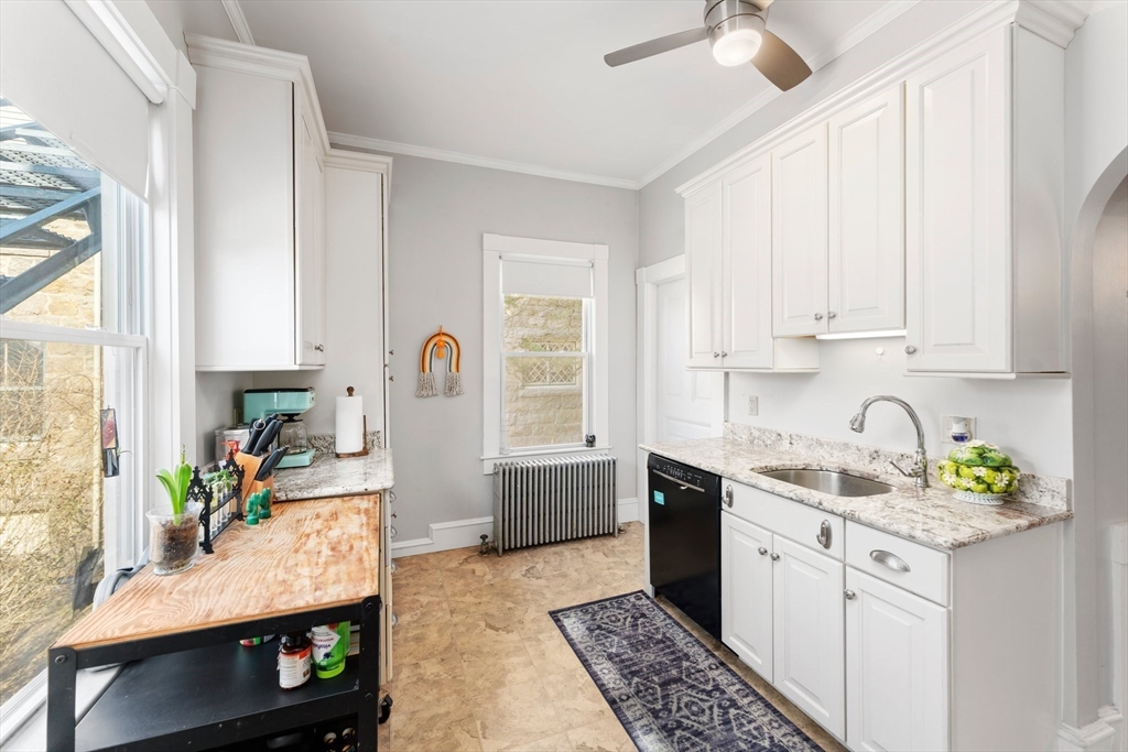 52 Underwood Street Fall River, MA 02720 - Photo 18 of 42 a kitchen with a sink stove and cabinets
