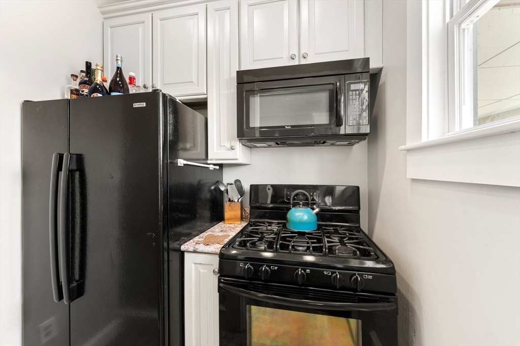 52 Underwood Street Fall River, MA 02720 - Photo 20 of 42 a kitchen with a stove and a microwave