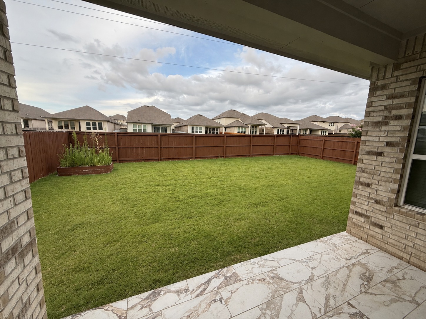 1213 Bryson Rdg Trail Leander, TX 78641 - Photo 16 of 16 A fully fenced backyard with verdant lawn, providing a private outdoor retreat.