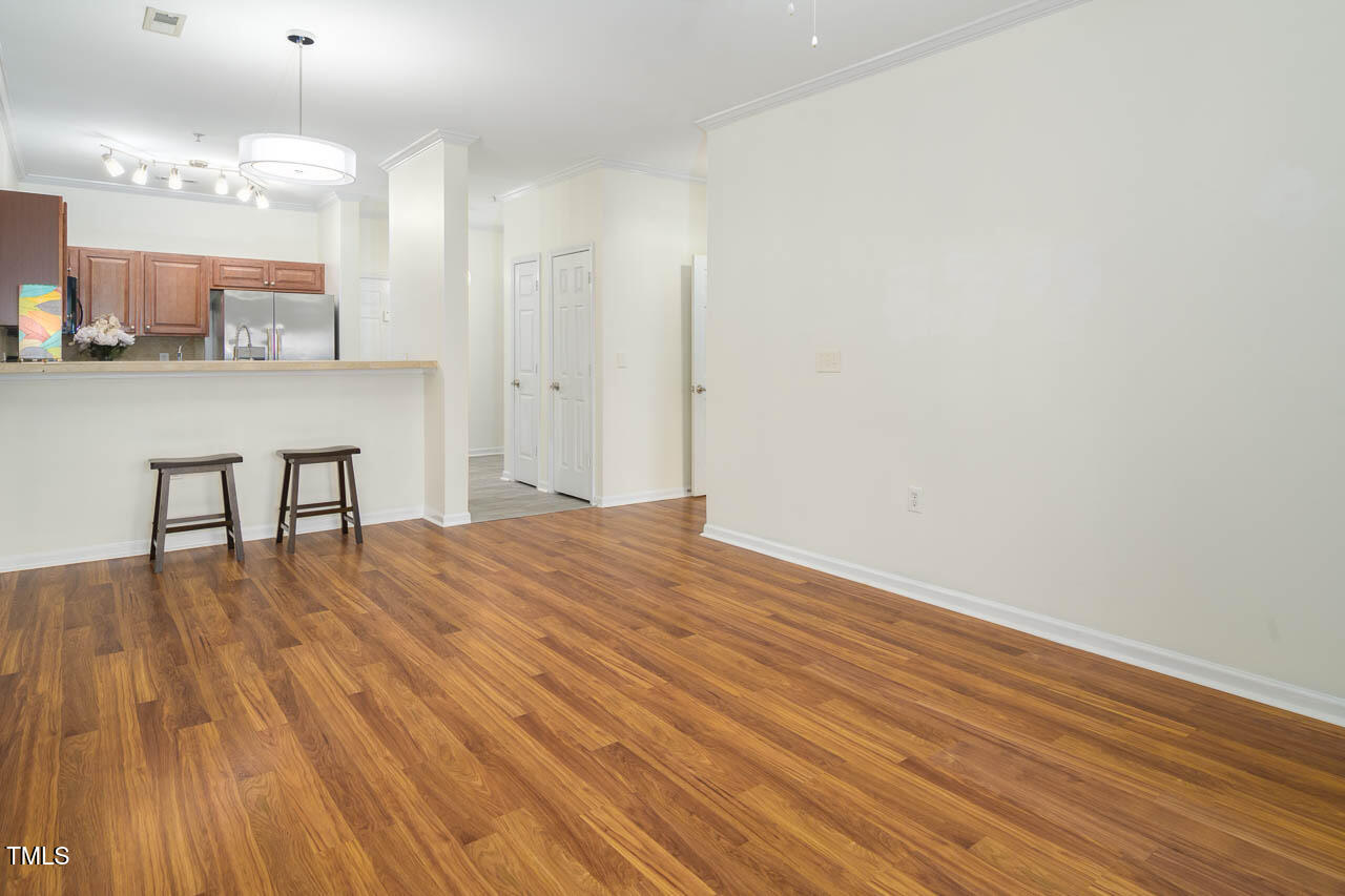 2610 Oldgate Drive, Unit 101 Raleigh, NC 27604 - Photo 10 of 23 a big room with wooden floor and dining table