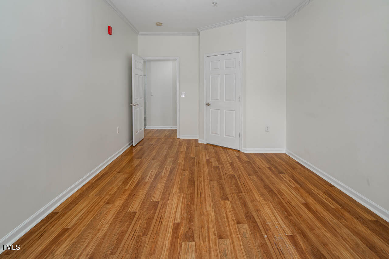 2610 Oldgate Drive, Unit 101 Raleigh, NC 27604 - Photo 14 of 23 a view of a room with wooden floor and white walls