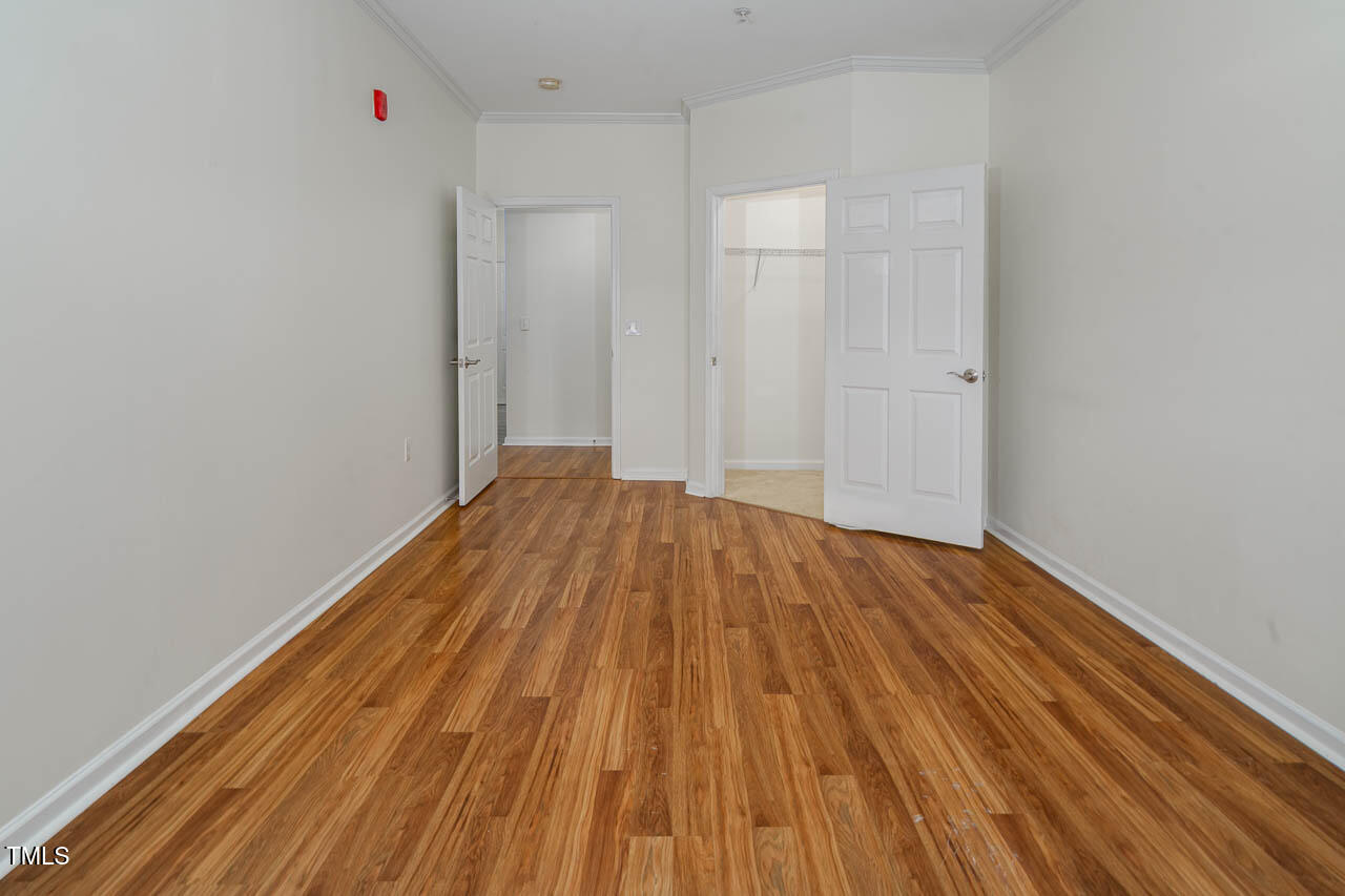 2610 Oldgate Drive, Unit 101 Raleigh, NC 27604 - Photo 16 of 23 a view of a room with wooden floor and white walls