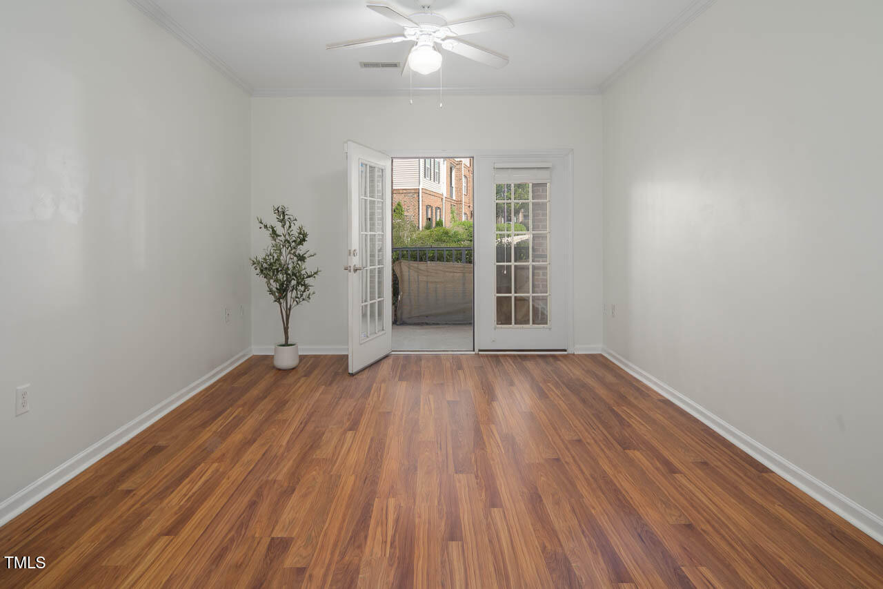 2610 Oldgate Drive, Unit 101 Raleigh, NC 27604 - Photo 8 of 23 wooden floor in an empty room with a window
