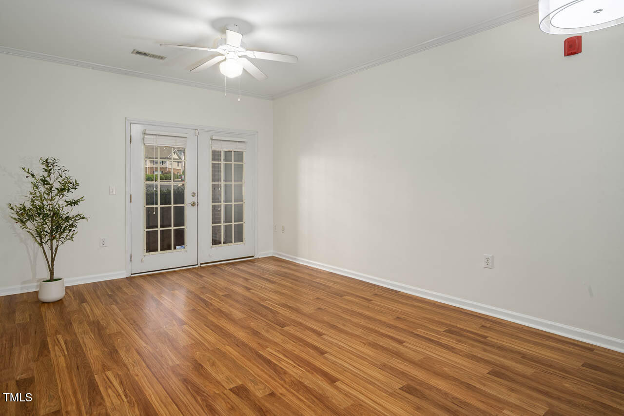 2610 Oldgate Drive, Unit 101 Raleigh, NC 27604 - Photo 9 of 23 a view of an empty room with a window and wooden floor