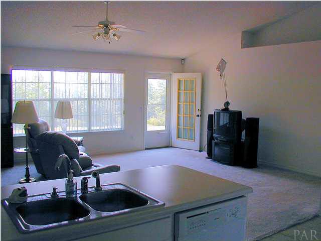 6843 Cedar Ridge Circle Milton, FL 32570 - Photo 3 of 11 Family Room--Note the oversized window to allow outlook to the green area in back of property. Nice storm door also allows visual of woods and lets in more light. Plant ledge on top right.