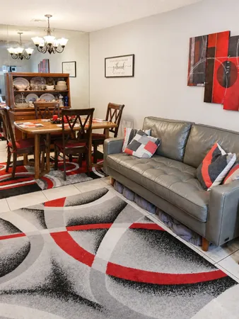 a living room with furniture and a rug