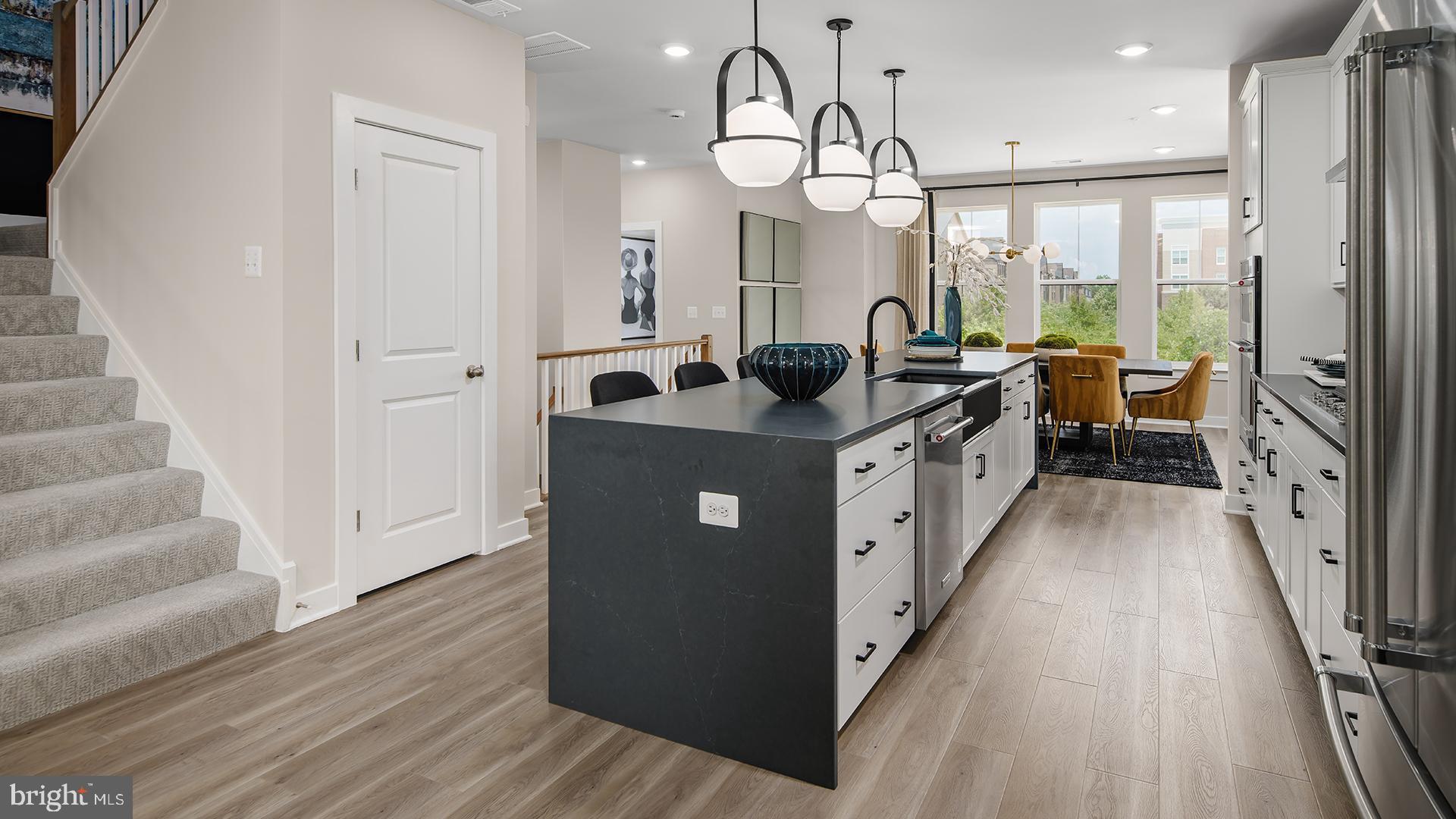 45175 Drowes Terrace Sterling, VA 20166 - Photo 2 of 14 a kitchen with stainless steel appliances granite countertop a lot of counter space and wooden floors